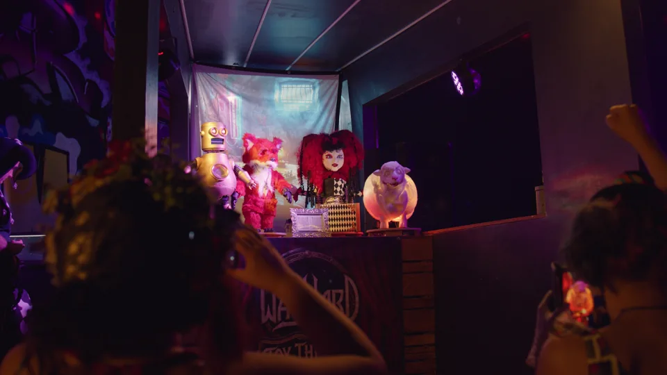 Audience members watching four animatronic characters at a live event